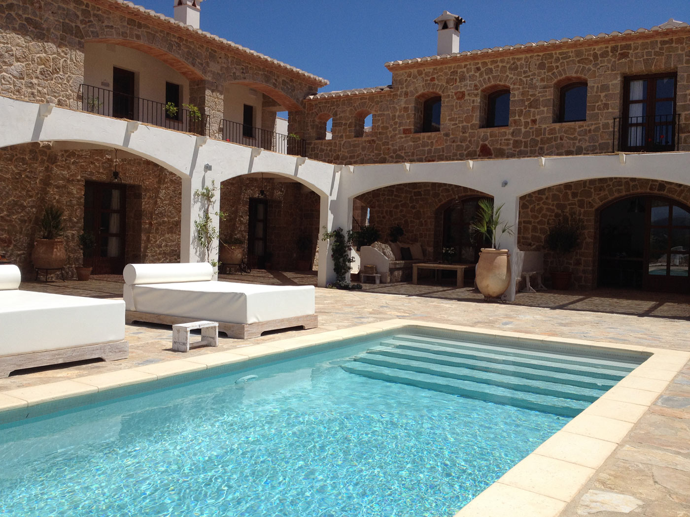 Pool with loungers and mountain views at Cuatre Finques