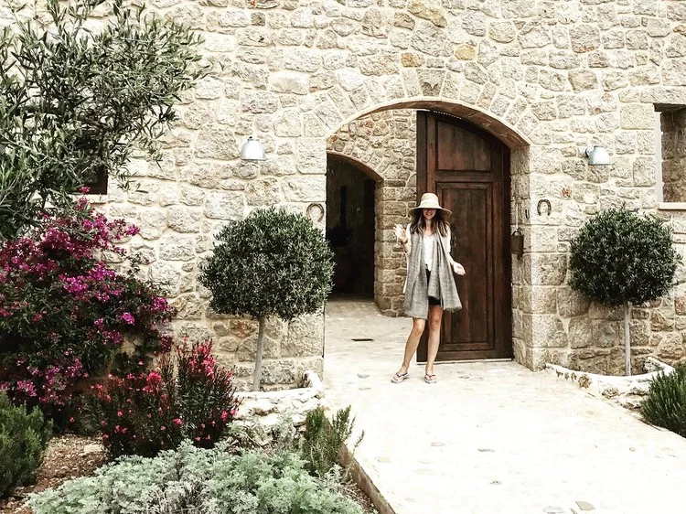 Portrait-style photo at the stone doorway of Cuatre Finques