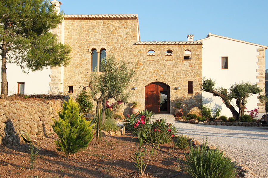 Stone facade and entrance of the Cuatre Finques finca